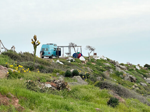 blue van perched on a hilltop